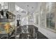 Stylish living room with a mirrored fireplace, shuttered windows, and glossy marble flooring at 174 Buena Ct, Henderson, NV 89074