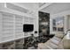 Bright living room with a fireplace, a large shelving unit, and a comfortable seating area at 174 Buena Ct, Henderson, NV 89074