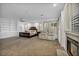 Open main bedroom with a fireplace, sitting area, carpet flooring, ceiling fan, and custom built-in cabinetry at 174 Buena Ct, Henderson, NV 89074