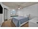Well-lit main bedroom with a window bench, ensuite bathroom, tv, and neutral carpet at 174 Buena Ct, Henderson, NV 89074
