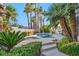 Inviting backyard pool and spa surrounded by beautiful landscaping and mature palm trees at 174 Buena Ct, Henderson, NV 89074