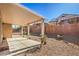 Backyard patio with a covered area and desert landscaping, perfect for outdoor living at 1805 Joy Grove Ave, Henderson, NV 89012