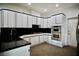 Modern kitchen with white cabinets, black countertops, and stainless steel appliances at 2010 Mondo Ct, Las Vegas, NV 89123