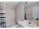 Bright bathroom featuring a tub-shower combo, white vanity and mirror at 2517 New Salem Ave, Henderson, NV 89052