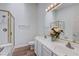 Bathroom featuring a glass shower, double vanity, and decorative flowers at 2517 New Salem Ave, Henderson, NV 89052