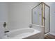 Bathroom featuring a soaking tub and glass shower with gold trim at 2517 New Salem Ave, Henderson, NV 89052