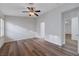 A bright bedroom featuring hardwood floors, ceiling fan, and ample natural light at 2517 New Salem Ave, Henderson, NV 89052