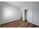 Well-lit bedroom boasts wood-look floors, fresh paint, and a closet at 2517 New Salem Ave, Henderson, NV 89052