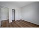 Bright bedroom featuring modern wood flooring, white trim, and a closet for storage at 2517 New Salem Ave, Henderson, NV 89052