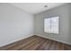 Bedroom showcasing wood floors, white walls, baseboards, and a window with blinds at 2517 New Salem Ave, Henderson, NV 89052