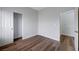 A bright bedroom with wood-look floors, closet and adjacent room entrance at 2517 New Salem Ave, Henderson, NV 89052