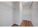 Walk-in closet with wood-look floors and custom shelving at 2517 New Salem Ave, Henderson, NV 89052