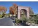 The Cottages community entrance with a stone archway and manicured landscaping at 2517 New Salem Ave, Henderson, NV 89052