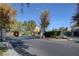 Community entrance featuring wrought iron gates, mature landscaping, and decorative holiday wreaths at 2517 New Salem Ave, Henderson, NV 89052