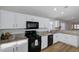 Modern kitchen featuring granite countertops, white cabinets, modern appliances and breakfast bar at 2517 New Salem Ave, Henderson, NV 89052