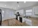 Well-lit kitchen featuring granite countertops, white cabinets and modern black appliances at 2517 New Salem Ave, Henderson, NV 89052