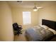 Comfortable bedroom featuring a ceiling fan and a large window at 2946 Plum Torte St, Las Vegas, NV 89122