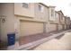 Inviting townhome featuring a two-car garage, neutral exterior, and well-maintained landscaping at 2946 Plum Torte St, Las Vegas, NV 89122