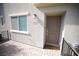 Tan front door of home featuring a paved entrance and a black railing at 2946 Plum Torte St, Las Vegas, NV 89122