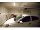 Bright garage featuring a car, drywall, and garage door mechanism at 2946 Plum Torte St, Las Vegas, NV 89122