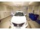 Spacious garage featuring a white car and two blue recycling bins at 2946 Plum Torte St, Las Vegas, NV 89122