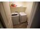 Laundry room featuring a full-sized washer, dryer, and storage shelf at 2946 Plum Torte St, Las Vegas, NV 89122