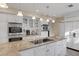 Bright kitchen featuring stainless steel appliances, white cabinetry, and granite countertops at 3141 E Katie Ave, Las Vegas, NV 89121