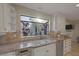 Kitchen showcasing tile backsplash, stainless steel appliances, granite counters, and a garden window at 3141 E Katie Ave, Las Vegas, NV 89121