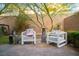 Relaxing backyard with patio seating, brick pavers, mature trees, and cozy atmosphere at 343 Cadence Vista Dr, Henderson, NV 89011
