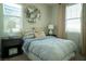 Cozy bedroom with a plush bed, decorative pillows, and a stylish round shelving unit at 343 Cadence Vista Dr, Henderson, NV 89011