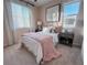 Cozy bedroom with soft, natural light from large window, side tables and stylish décor at 343 Cadence Vista Dr, Henderson, NV 89011
