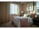 Cozy bedroom with soft, natural light from large window, side tables and stylish décor at 343 Cadence Vista Dr, Henderson, NV 89011