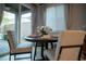 Bright dining area featuring a round table, modern chairs, and a sliding glass door to the backyard at 343 Cadence Vista Dr, Henderson, NV 89011