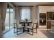 Cozy dining area features a round table, stylish chairs, and sliding glass doors for natural light at 343 Cadence Vista Dr, Henderson, NV 89011