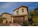 Charming two-story house boasts a two-car garage and inviting brick driveway amidst green landscaping at 343 Cadence Vista Dr, Henderson, NV 89011