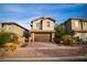 Attractive two-story house boasting a two-car garage and inviting brick driveway amidst lush landscaping at 343 Cadence Vista Dr, Henderson, NV 89011