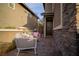 Cozy front patio with stylish seating, complemented by stone accents on the home's exterior, offers an inviting welcome at 343 Cadence Vista Dr, Henderson, NV 89011