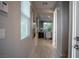 Bright hallway featuring wood-look tile floors, leading to the living area and showcasing natural light from a large window at 343 Cadence Vista Dr, Henderson, NV 89011