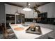 Modern kitchen boasting white countertops, dark backsplash, and stylish bar stools for a sleek, contemporary appeal at 343 Cadence Vista Dr, Henderson, NV 89011