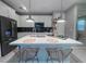 Contemporary kitchen with an island, bar seating, and modern appliances designed for convenient and stylish living at 343 Cadence Vista Dr, Henderson, NV 89011