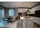 Well-lit open-concept kitchen and dining area with modern finishes and outdoor access at 343 Cadence Vista Dr, Henderson, NV 89011