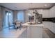 Bright kitchen features white cabinetry, stainless steel appliances, and a breakfast bar for casual dining and entertaining at 343 Cadence Vista Dr, Henderson, NV 89011