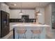 Modern kitchen showcasing bar stool seating, stainless appliances, and sleek countertops for meal preparation and enjoyment at 343 Cadence Vista Dr, Henderson, NV 89011