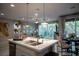Open kitchen area with pendant lighting, island seating, and seamless flow to the living and dining spaces at 343 Cadence Vista Dr, Henderson, NV 89011