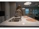 Spacious kitchen island featuring a stainless steel sink, ample counter space and bar seating at 343 Cadence Vista Dr, Henderson, NV 89011