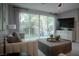 Modern living room with a comfortable sofa, large windows offering backyard views, and a sleek media console at 343 Cadence Vista Dr, Henderson, NV 89011
