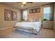 Cozy main bedroom featuring a upholstered bed and three windows at 343 Cadence Vista Dr, Henderson, NV 89011