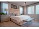 Cozy main bedroom featuring a upholstered bed and three windows at 343 Cadence Vista Dr, Henderson, NV 89011