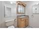 Well-lit bathroom with wooden vanity, decorative mirror, and tiled floor at 4216 Sawyer Ave, Las Vegas, NV 89108