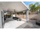 Expansive covered patio includes a seating area and an outdoor kitchen setup, perfect for entertaining at 4650 Wonderful St, Las Vegas, NV 89147